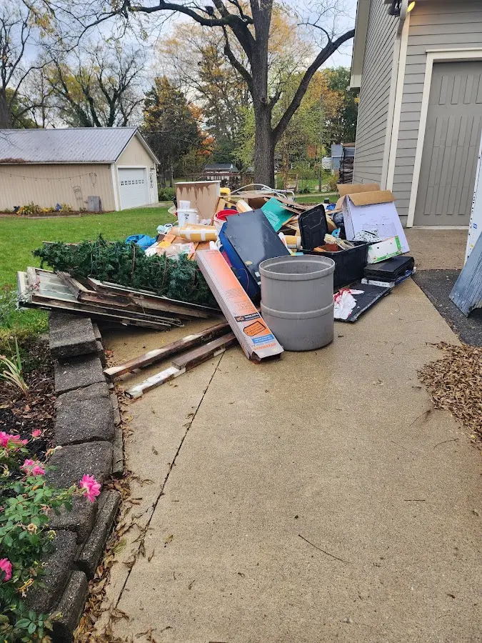 Dumpster being loaded with debris for Roofing Dumpster Rental in Williamson
